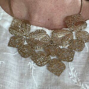 Gold colored necklace; light weight leaf 🍃 🍁 design.  Adjustable length.